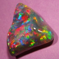Opal with triangular shape and baroque face